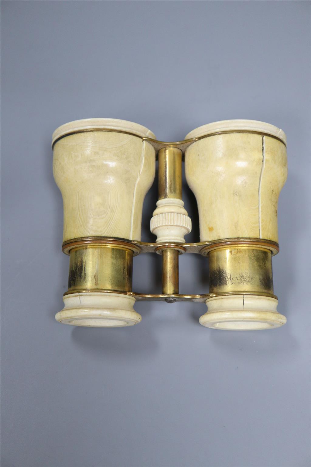 A pair of ivory binoculars and an ivory figure, height 9cm